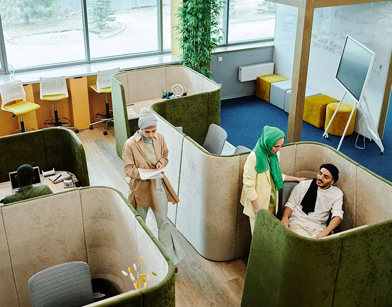 Professionals working in flexible seating booths