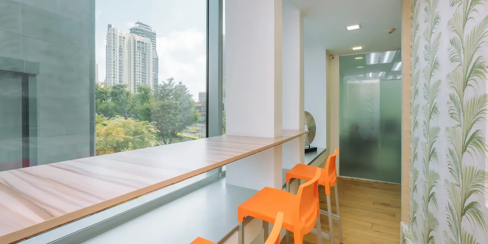 Modern office interior view with bright seating facing city view
