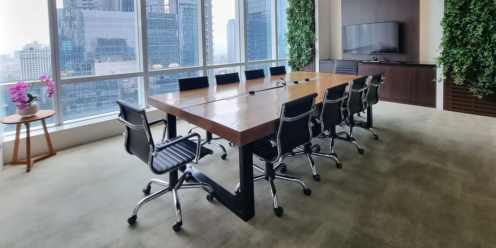 Spacious corporate boardroom table with city skyline view