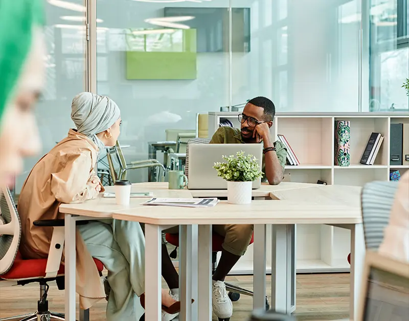 Professionals discussing business strategies in a modern flexible office
