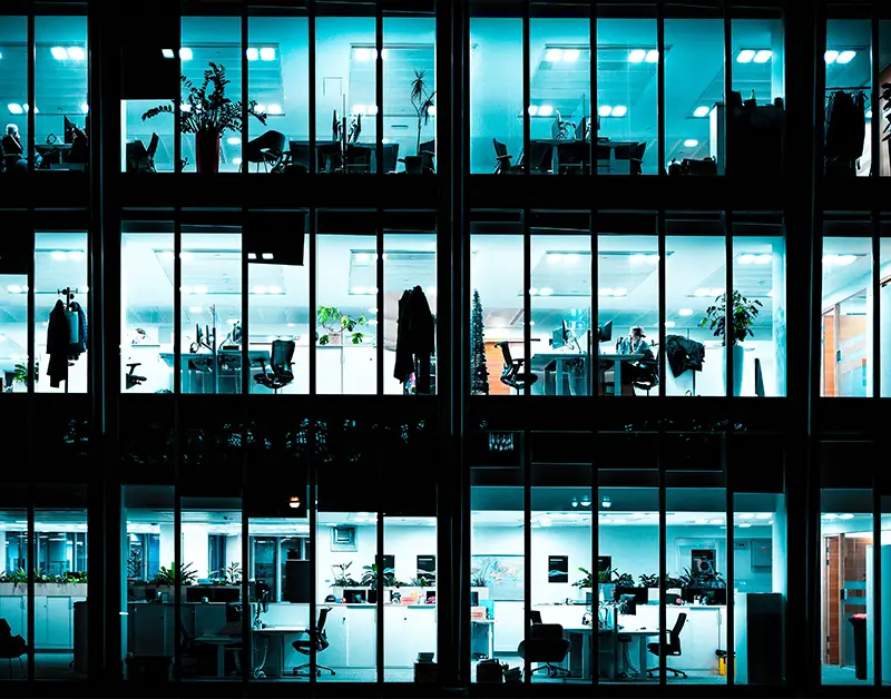 Corporate office rental space with illuminated windows at night