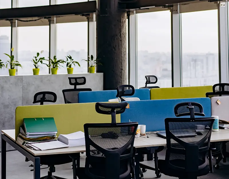 Modern office workspace with desks and natural light