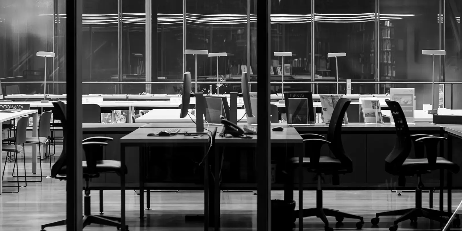 Workstations illuminated in a modern corporate office at night